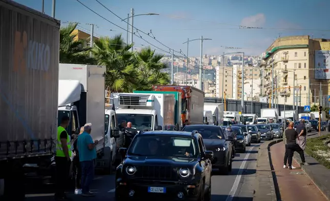 Trucks are parked along the street during a truckers' protest in Naples, Italy, over high fuel prices, Tuesday, Oct. 20, 2026. (Alessandro Garofalo/LaPresse via AP)