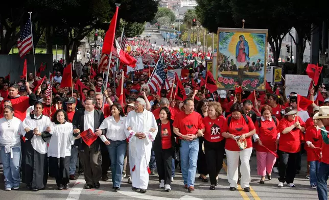 FILE - Dolores Huerta, center in black jacket, co-founder of the United Farm Workers union, joins UFW members and their supporters during a rall, March 26, 2006, in downtown Los Angeles, to mark union founder Cesar Chavez's birthday and to protest pending federal legislation aimed at cracking down on illegal immigration. (AP Photo/Ric Francis, File)