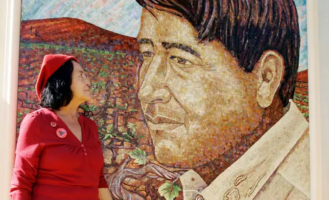 FILE - United Farm Workers co-founder Dolores Huerta looks at a mural of the late Cesar Chavez during a dedication of the Cesar Chavez Monument on the San Jose State University campus in San Jose, Calif., Sept. 4, 2008. (AP Photo/Paul Sakuma, File)