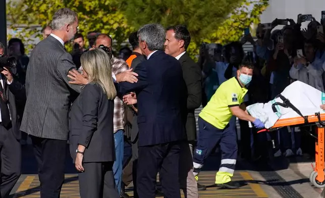 Spain's King Felipe VI, left, arrives to visit people injured in a train collision in Toledo, Spain, Thursday, Oct. 29, 2026. (AP Photo/Andrea Comas)
