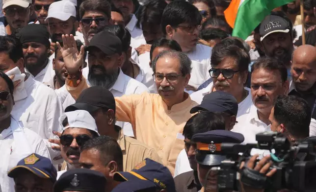 Shiv Sena (UBT) leader Uddhav Thackeray waves as he marches during a protest organized by his party and the Maharashtra Navnirman Sena (MNS), demanding the resignation of Chief Election Commissioner Gyanesh Kumar and the suspension of the Special Intensive Revision (SIR) of electoral rolls, in Mumbai, India, Sunday, Oct. 4, 2026.(AP Photo/Rafiq Maqbool)