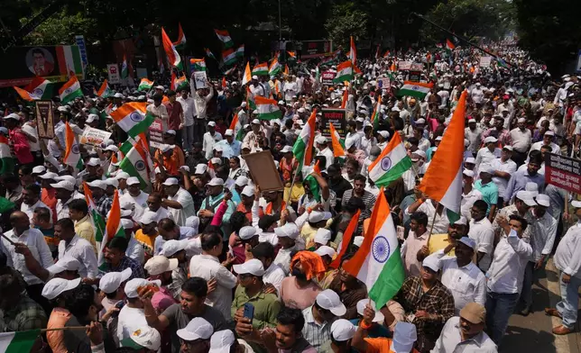 Protesters hold placards during a protest organized by Shiv Sena (UBT) and the Maharashtra Navnirman Sena, demanding the resignation of Chief Election Commissioner Gyanesh Kumar and the suspension of the Special Intensive Revision (SIR) of electoral rolls, in Mumbai, India, Sunday, Oct. 4, 2026.(AP Photo/Rafiq Maqbool)