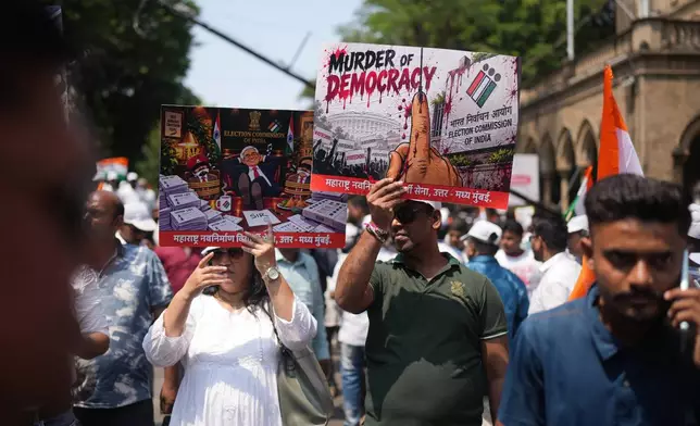 Protesters hold placards during a protest organized by Shiv Sena (UBT) and the Maharashtra Navnirman Sena, demanding the resignation of Chief Election Commissioner Gyanesh Kumar and the suspension of the Special Intensive Revision (SIR) of electoral rolls, in Mumbai, India, Sunday, Oct. 4, 2026.(AP Photo/Rafiq Maqbool)