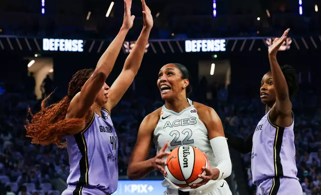 The Golden State Valkyries center Kiah Stokes (41) and guard Kaila Charles (6) block Las Vegas Aces center A'ja Wilson (22) during Game 2 of the WNBA Semifinals in San Francisco, Wednesday, Oct. 7, 2026. (Santiago Mejia/San Francisco Chronicle via AP)