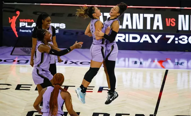 Golden State Valkyries guard Kaitlyn Chen (2) and Golden State Valkyries guard Veronica Burton (22) celebrate their win against the Las Vegas Aces during Game 2 of the WNBA Semifinals in San Francisco, Wednesday, Oct. 7, 2026. (Yalonda M. James/San Francisco Chronicle via AP)
