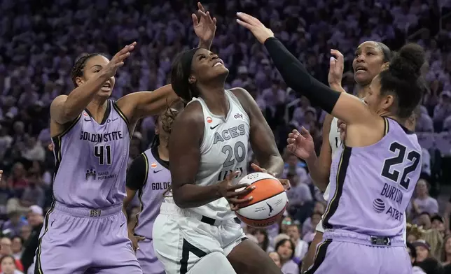 Las Vegas Aces center Kalani Brown (20) tries to shoot between Golden State Valkyries center Kiah Stokes (41) and guard Veronica Burton (22) during the second half of Game 2 of the WNBA basketball semifinals, Wednesday, Oct. 7, 2026, in San Francisco. (AP Photo/Jeff Chiu)