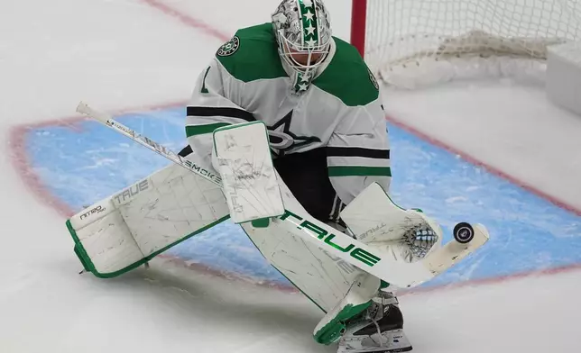 Dallas Stars goaltender Casey DeSmith makes a stick save in the second period of an NHL hockey game against the Colorado Avalanche Wednesday, Oct. 14, 2026, in Denver. (AP Photo/David Zalubowski)