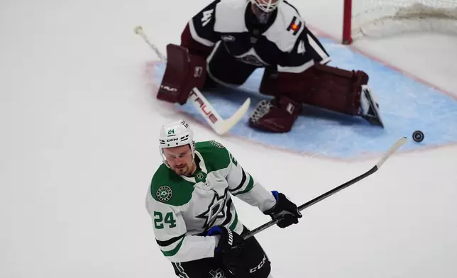 Dallas Stars center Roope Hintz, front, reacts after scoring the winning goal against Colorado Avalanche goaltender Scott Wedgewood during the shootout of an NHL hockey game Wednesday, Oct. 14, 2026, in Denver. (AP Photo/David Zalubowski)