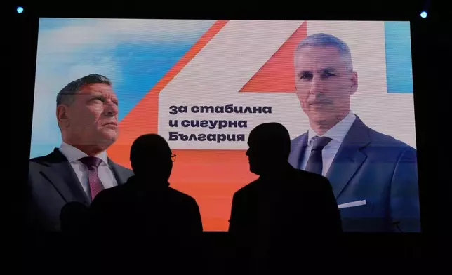 Posters featuring independent presidential candidate Andrey Gyurov and his vice-presidential running mate, Georgi Kandev are displayed on screens during their campaign's closing event in Plovdiv, Bulgaria, on Oct. 21, 2026. (AP Photo/Valentina Petrova)