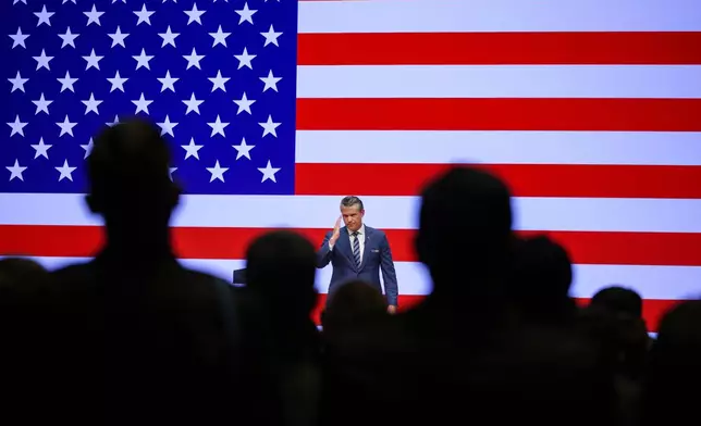 Secretary of Defense Pete Hegseth salutes troops after giving a State of the Force address at Marine Corps Base Quantico, Wednesday, Sept. 30, 2026 in Quantico, Va. (Alex Wong/Pool Photo via AP)