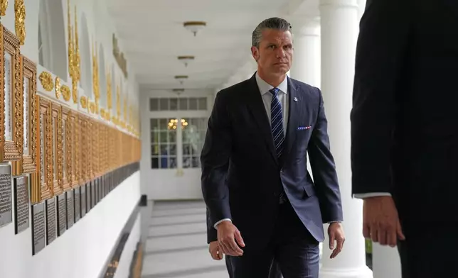 Defense Secretary Pete Hegseth walks along the Colonnade before President Donald Trump and China's President Xi Jinping at the White House, Thursday, Sept. 24, 2026, in Washington. (AP Photo/Jacquelyn Martin)