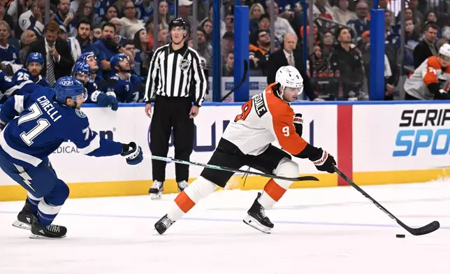 Philadelphia Flyers defenseman Jamie Drysdale (9) handles the puck against Tampa Bay Lightning center Anthony Cirelli (71) during the first period of an NHL hockey game Monday, Oct. 5, 2026, in Tampa, Fla. (AP Photo/Jason Behnken)