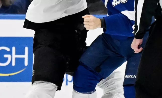 Philadelphia Flyers defenseman Simon Benoit (44) and Tampa Bay Lightning left wing Jeffrey Viel (25) fight during the third period of an NHL hockey game Monday, Oct. 5, 2026, in Tampa, Fla. (AP Photo/Jason Behnken)