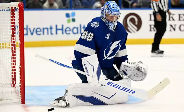 Tampa Bay Lightning goaltender Andrei Vasilevskiy makes a save during the first period of an NHL hockey game against the Philadelphia Flyers ,Monday, Oct. 5, 2026, in Tampa, Fla. (AP Photo/Jason Behnken)
