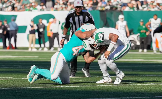 Miami Dolphins linebacker Chop Robinson (44) sacks New York Jets quarterback Geno Smith (7) in the second half of an NFL football game in East Rutherford, N.J., Sunday, Oct. 25, 2026. (AP Photo/Seth Wenig)