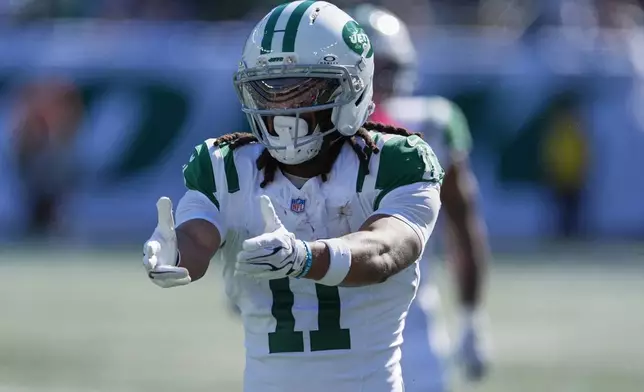 New York Jets wide receiver Omar Cooper Jr. (11) celebrates a first down against the Miami Dolphins in the first half of an NFL football game in East Rutherford, N.J., Sunday, Oct. 25, 2026. (AP Photo/Seth Wenig)