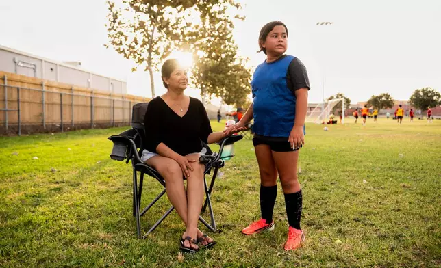 Kathryn Shergold low-fives her mother Cindy Banda before returning to soccer practice, Sept. 16, 2026, in McAllen, Texas. (AP Photo/Julia Demaree Nikhinson)