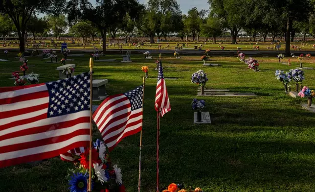 American flags fly over graves at Funeraria del Angel Highland Funeral Home and Memorial Park, where Melissa Banda is entombed, Sept. 17, 2026, in Weslaco, Texas. (AP Photo/Julia Demaree Nikhinson)