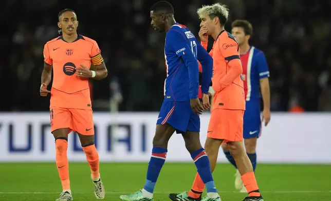 PSG's Ousmane Dembele, center, leaves the field with an injury during the Champions League opening phase soccer match between Paris Saint-Germain and FC Barcelona in Paris, Tuesday, Oct. 20, 2026. (AP Photo/Thibault Camus)