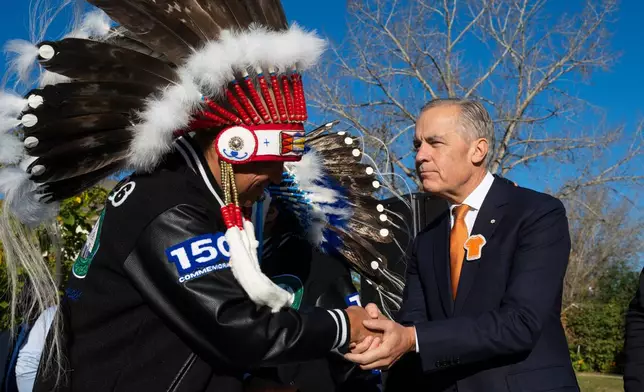 Canada Prime Minister Mark Carney, right, attends the National Day for Truth and Reconciliation event, Wednesday Sept. 30, 2026, in Edmonton, Alberta. (John Ulan/The Canadian Press via AP)