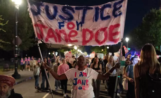 Demonstrators march from the Washington Monument to the White House during a "Stop Sexual Violence" protest in Washington, Thursday, Oct. 8, 2026. (AP Photo/Jose Luis Magana)