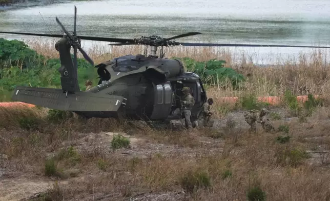 Troops disembark from a U.S. Army helicopter on an island along the Rio Grande in Roma, Texas, Thursday, Oct. 8, 2026. (AP Photo/Eric Gay)