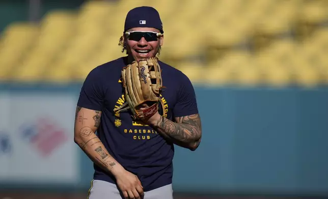 Milwaukee Brewers catcher William Contreras shares a light moment with teammates during a workout ahead of Game 3 of baseball's National League Championship Series against the Los Angeles Dodgers, Tuesday, Oct. 13, 2026, in Los Angeles. (AP Photo/Jae C. Hong)