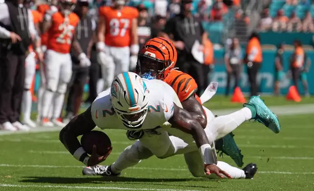 Cincinnati Bengals linebacker Barrett Carter sacks Miami Dolphins quarterback Malik Willis (2) during the second half of an NFL football game in Miami Gardens, Fla., Sunday, Oct. 11, 2026. (AP Photo/Rebecca Blackwell)