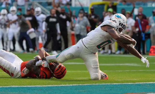 Cincinnati Bengals safety Bryan Cook (6) stops Miami Dolphins running back Ollie Gordon II (0) short of the goal line during the second half of an NFL football game in Miami Gardens, Fla., Sunday, Oct. 11, 2026. (AP Photo/Rebecca Blackwell)