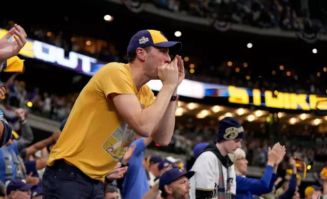 Milwaukee Brewers fans cheer during the eighth inning of Game 1 of baseball's World Series, Friday, Oct. 23, 2026, in Milwaukee, between the Milwaukee Brewers and the Tampa Bay Rays. (AP Photo/Ashley Landis)