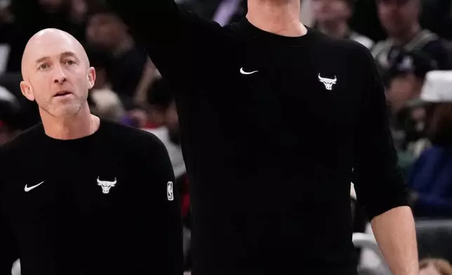 Chicago Bulls head coach Tiago Splitter, right, gives directions during the second half of an NBA basketball game against the Milwaukee Bucks, Friday, Oct. 23, 2026, in Milwaukee. (AP Photo/Nam Y. Huh)