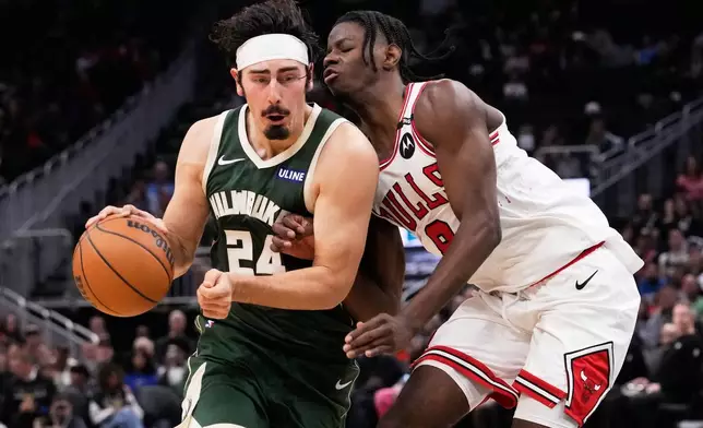 Chicago Bulls forward Caleb Wilson, right, guards against Milwaukee Bucks guard Jaime Jaquez Jr. (24) during the second half of an NBA basketball game Friday, Oct. 23, 2026, in Milwaukee. (AP Photo/Nam Y. Huh)
