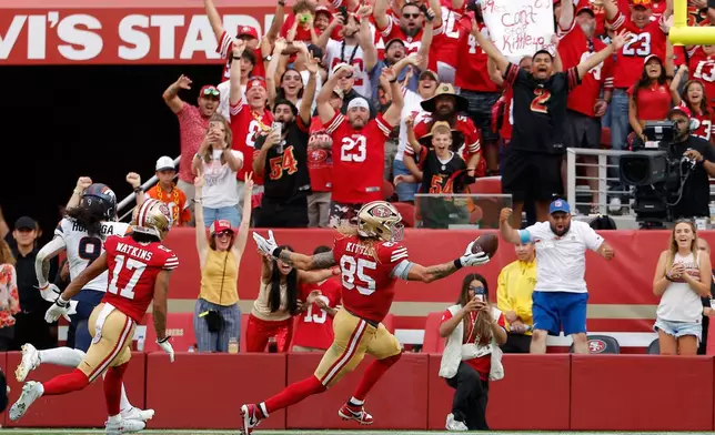 Fan react as San Francisco 49ers tight end George Kittle (85) celebrates after scoring against the Denver Broncos during the second half of an NFL football game in Santa Clara, Calif., Sunday, Oct. 4, 2026. (AP Photo/Kelley L. Cox)
