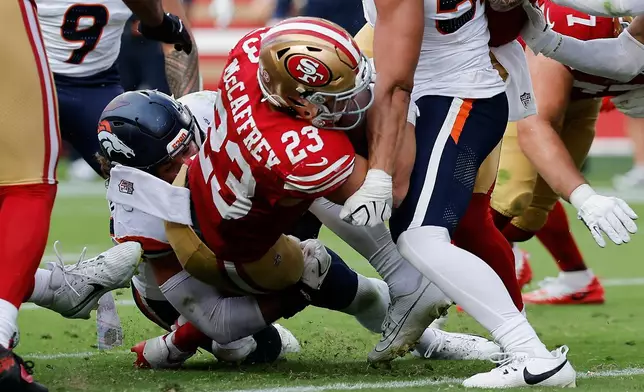 San Francisco 49ers running back Christian McCaffrey (23) runs for a touchdown during the second half of an NFL football game against the Denver Broncos in Santa Clara, Calif., Sunday, Oct. 4, 2026. (AP Photo/Kelley L. Cox)