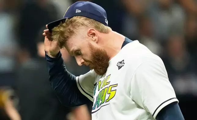 Tampa Bay Rays pitcher Cam Booser leaves the game during the fifth inning of Game 3 of baseball's World Series, Monday, Oct. 26, 2026, in St. Petersburg, Fla., between the Milwaukee Brewers and the Tampa Bay Rays. (AP Photo/Ashley Landis)