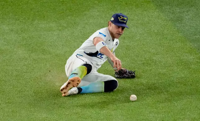 Tampa Bay Rays shortstop Taylor Walls fields a two-RBI base hit by Milwaukee Brewers second baseman Brice Turang during the fifth inning of Game 3 of baseball's World Series, Monday, Oct. 26, 2026, in St. Petersburg, Fla., between the Milwaukee Brewers and the Tampa Bay Rays. (AP Photo/Morry Gash)