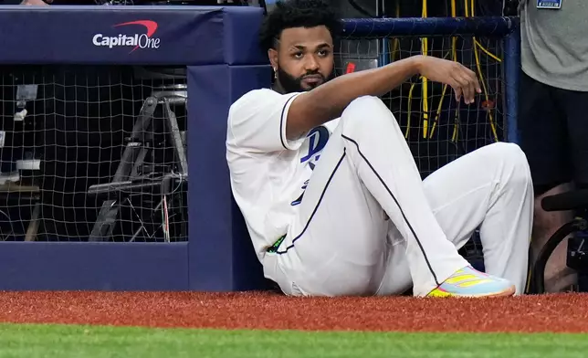 Tampa Bay Rays third baseman Junior Caminero watches from the dugout during the eighth inning of Game 3 of baseball's World Series, Monday, Oct. 26, 2026, in St. Petersburg, Fla., between the Milwaukee Brewers and the Tampa Bay Rays. (AP Photo/Chris O'Meara)