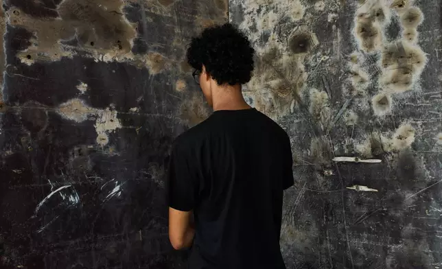 A 17-year-old aspiring model from northern Morocco, who did not want his name used because he was unaccompanied and feared for his safety, poses for a photograph during an interview near El Trampolín Beach in the Spanish enclave of Ceuta, Wednesday, Sept. 30, 2026. (AP Photo/Bernat Armangue)