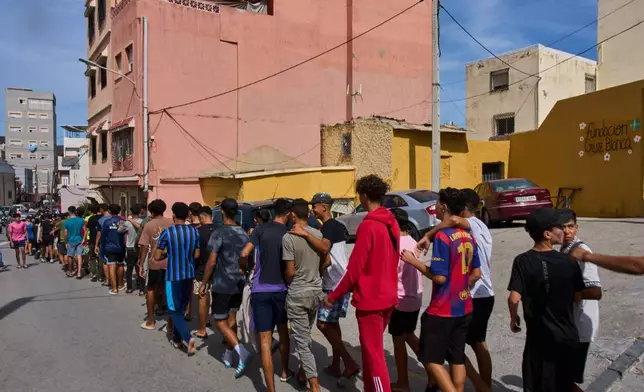 A group of migrant minors walk in the Spanish enclave of Ceuta, Thursday, Oct. 1, 2026. (AP Photo/Bernat Armangue)