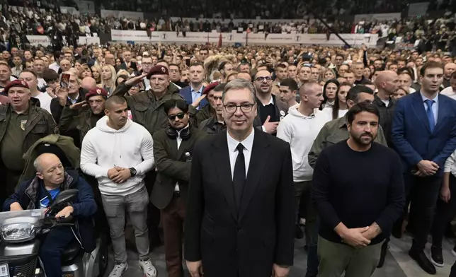 Serbia's populist leader Aleksandar Vucic, center, listens to the Serbian national anthem with supporters during a pre-election rally of his ruling Serbian Progressive Party ahead of the early parliamentary election scheduled for Oct. 25, in Belgrade, Serbia, Thursday, Oct. 22, 2026. (AP Photo)
