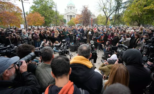 Jovan Vujicic, center, an assistant professor at the Faculty of Law of the University of Kragujevac, speaks during a news conference by Serbia's student movement demanding the resignations of top police and security officials in Belgrade, Serbia, Thursday, Oct. 29, 2026. (AP Photo/Darko Vojinovic)