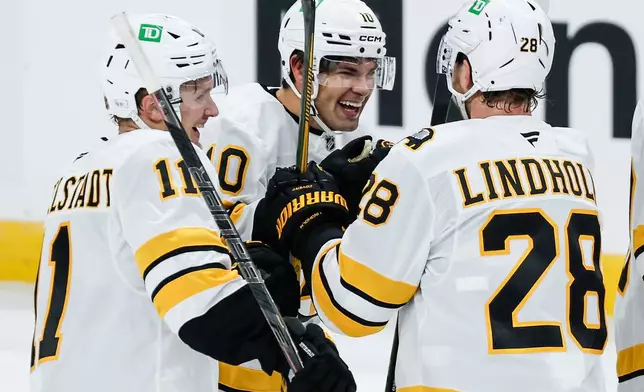 Boston Bruins' JJ Peterka (10) celebrates after his winning goal against the Winnipeg Jets in overtime of an NHL hockey game in Winnipeg, Manitoba, Friday, Oct. 2, 2026. (John Woods/The Canadian Press via AP)