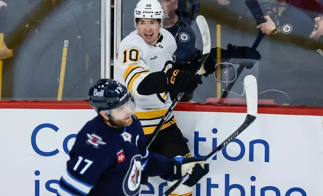 Boston Bruins' JJ Peterka (10) celebrates after his winning goal against the Winnipeg Jets in overtime of an NHL hockey game in Winnipeg, Manitoba, Friday, Oct. 2, 2026. (John Woods/The Canadian Press via AP)