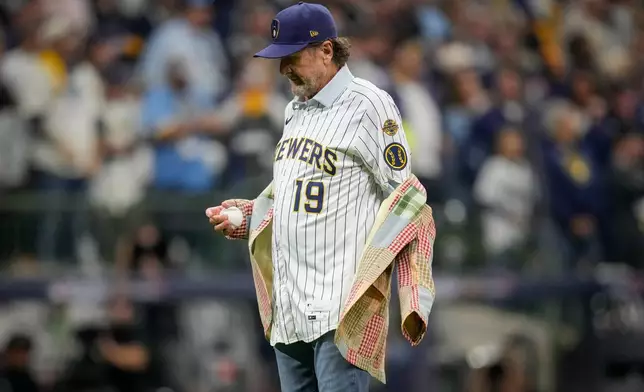 Baseball hall of famer Robin Yount takes off his jacket before the ceremonial first pitch prior to Game 1 of baseball's World Series, Friday, Oct. 23, 2026, in Milwaukee, between the Milwaukee Brewers and the Tampa Bay Rays. (AP Photo/Ashley Landis)