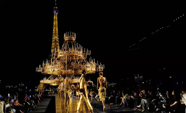 Models wear creations as part of the Saint Laurent Womenswear Spring Summer 2027 collection presented in Paris, France, Tuesday, Sept. 29, 2026. (AP Photo/Teresa Suarez)