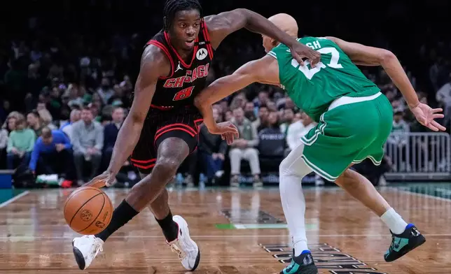 Chicago Bulls' Caleb Wilson (8) drives around Boston Celtics' Jordan Walsh (27) during the first half of an NBA basketball game, Monday, Oct. 26, 2026, in Boston. (AP Photo/Charles Krupa)