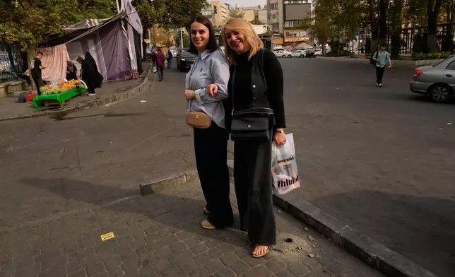 Women pose for a photo in Tajrish Square in Tehran, Iran, Thursday, Oct. 22, 2026. (AP Photo/Vahid Salemi)