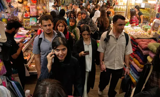 People walk at Tajrish traditional bazaar in Tehran, Iran, Thursday, Oct. 22, 2026. (AP Photo/Vahid Salemi)