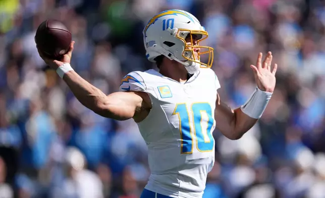 Los Angeles Chargers quarterback Justin Herbert throws a pass during the first half of an NFL football game against the Seattle Seahawks, Sunday, Oct. 4, 2026, in Seattle. (AP Photo/Lindsey Wasson)