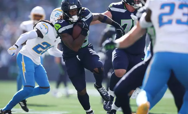 Seattle Seahawks running back Emanuel Wilson (23) runs up field during a touchdown reception in the first half of an NFL football game against the Los Angeles Chargers, Sunday, Oct. 4, 2026, in Seattle. (AP Photo/Kevin Ng)